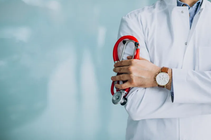 Fertility specialist holding red stethoscope
