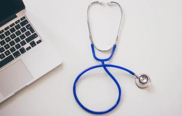 Digital marketing dentists concept with stethoscope and laptop on white background