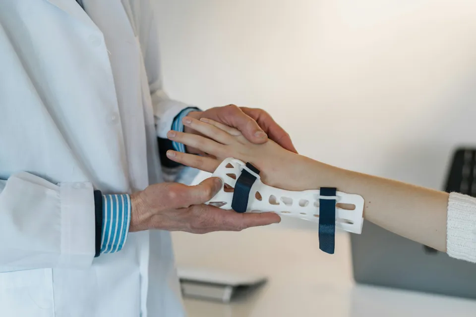 Doctor fitting 3D-printed wrist support for a patient — demonstrating advanced medical technologies in private practices